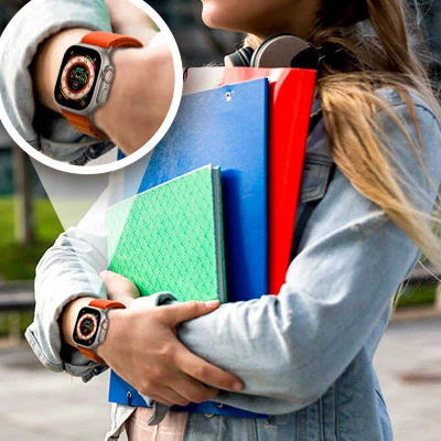 Female college student walking on campus with smartwatch