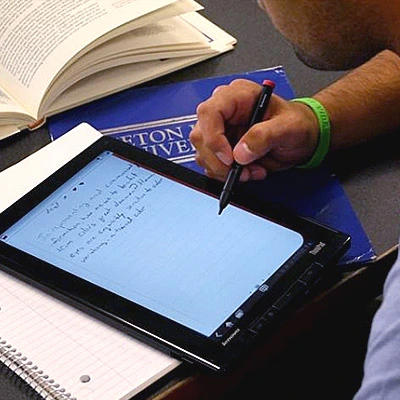 College Student taking notes on tablet device