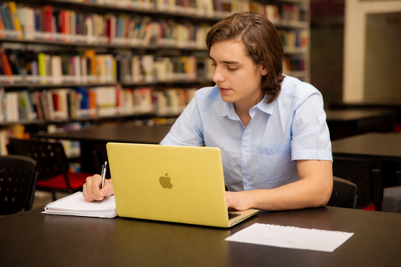 Student using Macbook Neo in library